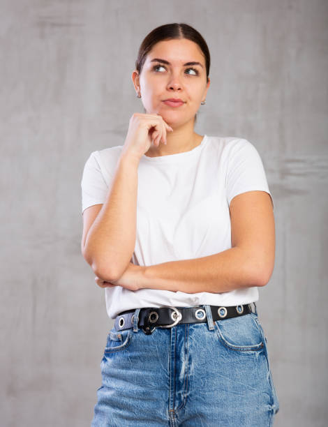 istock Thoughtful young woman standing in contemplative position 1470797724