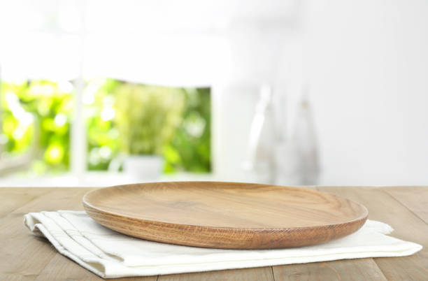 istock Empty plate and napkin on wooden table indoors. Bokeh effect 1470797736