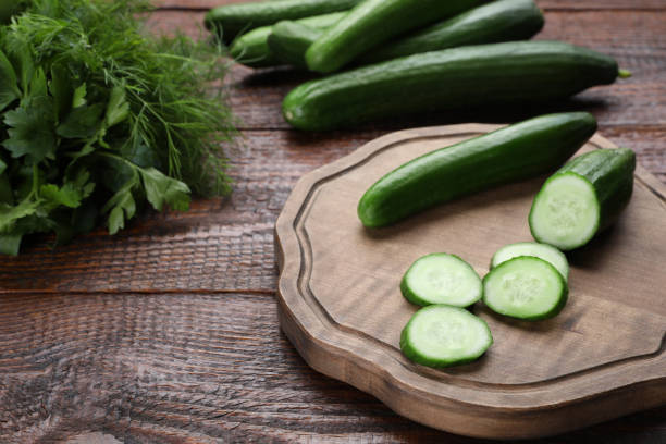 istock Fresh ripe cucumbers, parsley and dill on wooden table 1470798567