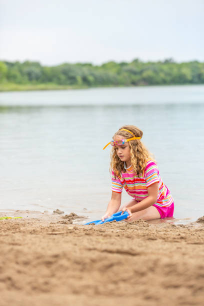 Asian girl play toys in the beach. The concept of holiday activities. High quality photo