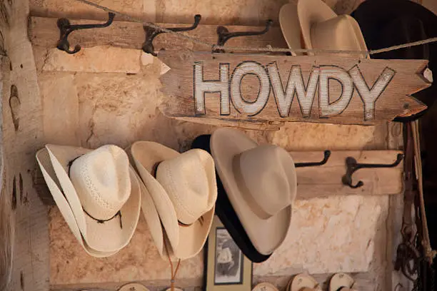 Photo of Howdy sign and hats for sale