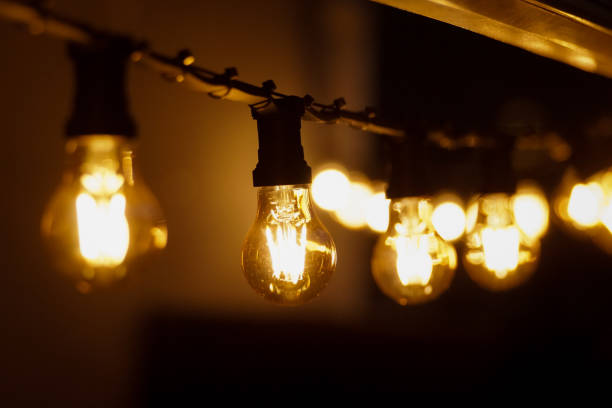 istock Close up of illuminated light bulbs hanging 1470803611