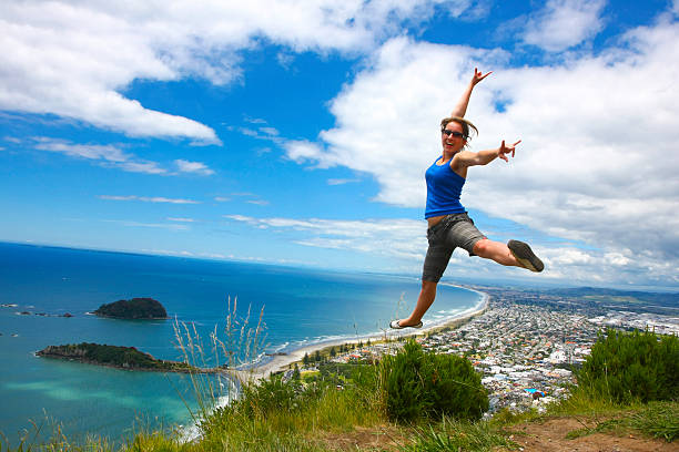 Cheerful outdoor woman on the beach doing a handstand