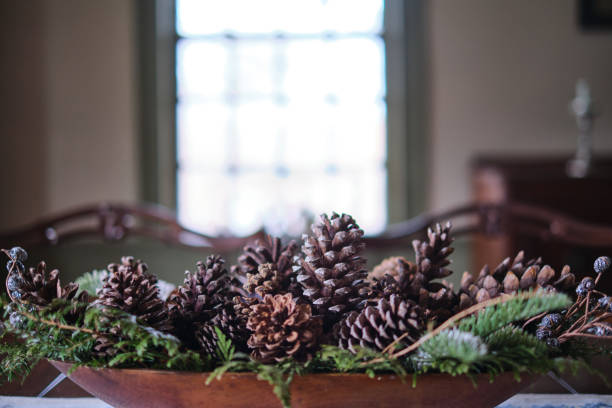 istock Old fashioned festive table display of pine cones and boughs 1470803819