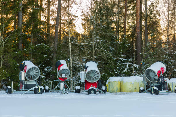 Snowmaking  with snow gun.  Ski slope artificial snowing. Ski resort  with snow cannon - snow making machine. Beautiful winter nature. Fresh snow on the top of  mountains.  High mountain landscape  Ski area.