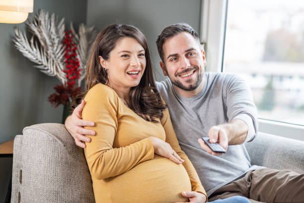 istock Happily married couple sitting on the sofa 1470804653