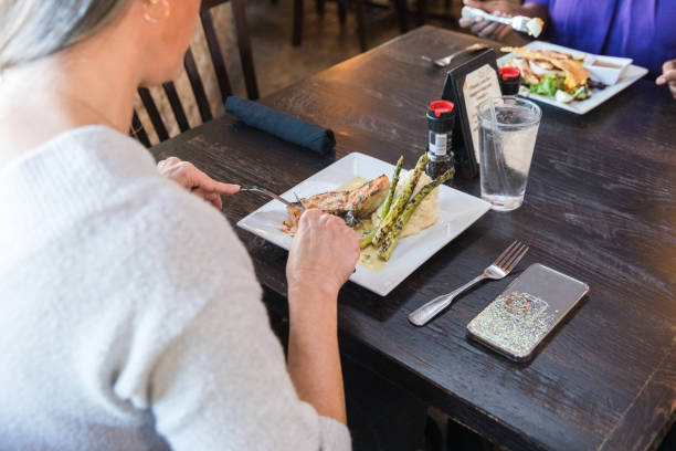 istock Over the shoulder view of unrecognizable people enjoying lunch 1470804764