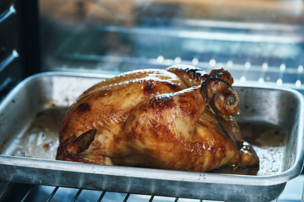 istock Preparing Roasted Chicken with Root Vegetables in Domestic Kitchen 1470805170