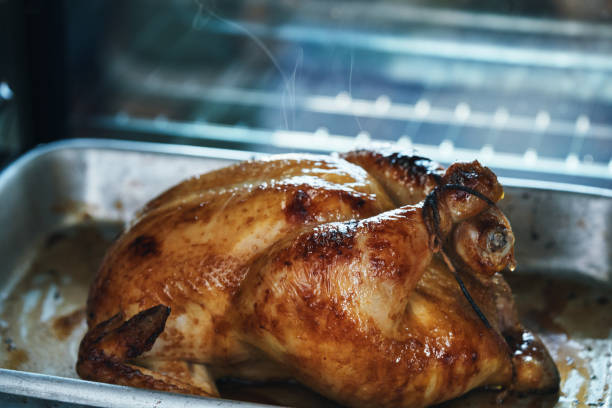 istock Preparing Roasted Chicken with Root Vegetables in Domestic Kitchen 1470805177