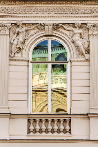 Vienna Opera reflecting in the window of typical moudeling facade