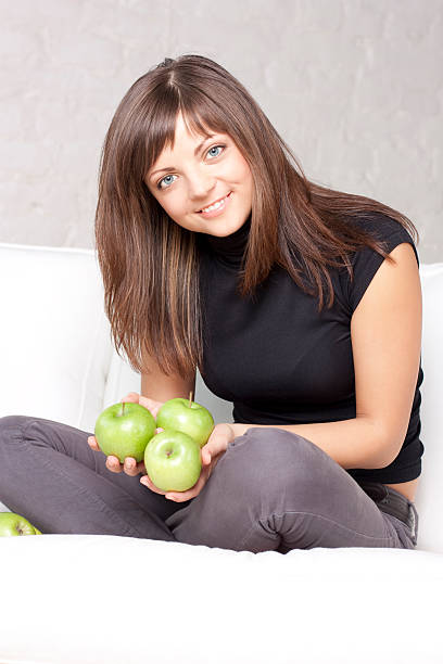 istock beautiful smiling girl with green apples 147080791