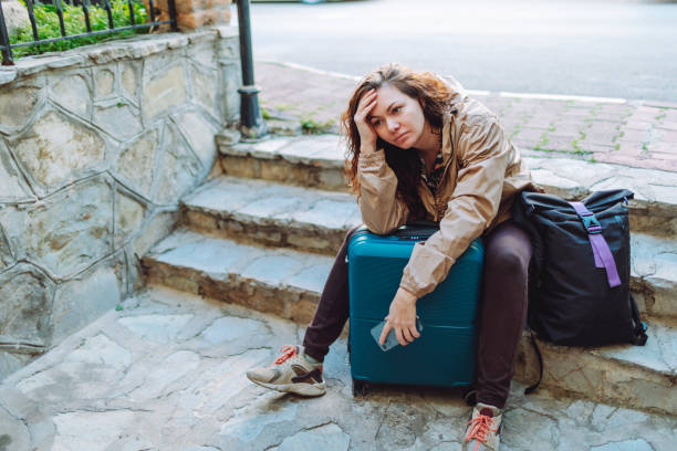 istock Young woman with suitcase  getting lost and searching hotel 1470809722