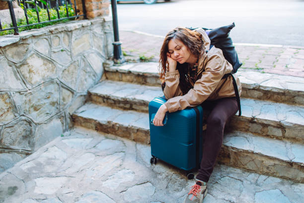 istock Young woman with suitcase  getting lost and searching hotel 1470809723