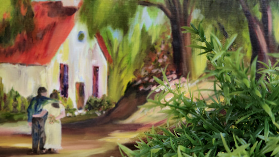 Green shrub in foreground.  Couple in background in soft focus.  Church or school building.  Reminiscent of times gone by.