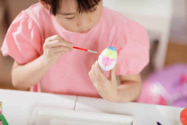 medium shot of young girl was making Easter craft and decorations at home