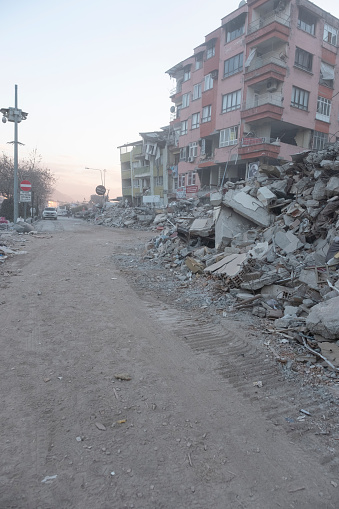 Hatay, Turkey February 15, 2023\nThe street was closed to traffic because of the collapsed buildings. A building that survived the earthquake.