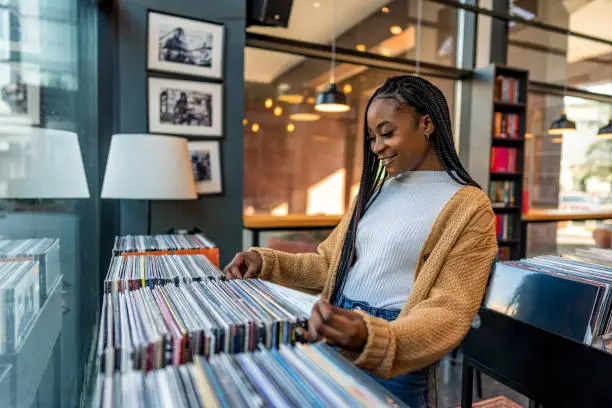 Photo of Woman choosing vinyl record in music record shop