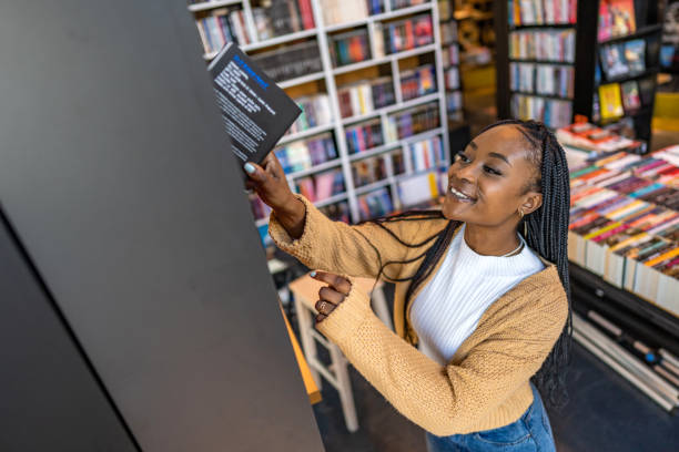 istock African american female student stands in university library, looking for a book. 1470815005