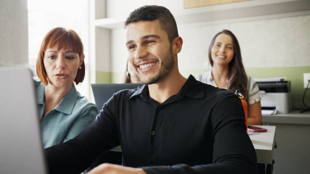 istock Smiling adult students studying together during a class 1470815044