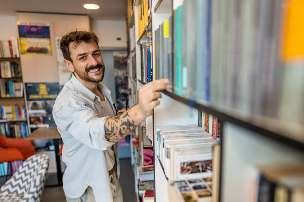 istock Happy male freelancer or student standing in modern office or university library 1470815045