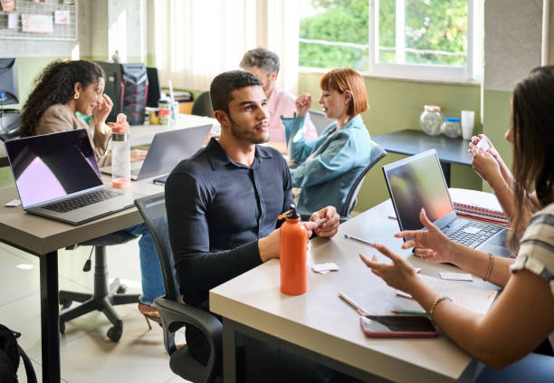 istock Group of adult students discussing studies after the lecture in classroom 1470816220