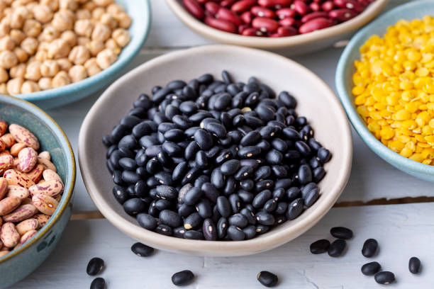 istock Different types of legumes in bowls - black beans 1470821302