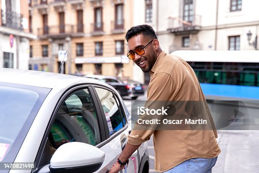 istock man renting a car through a mobile application. car sharing, car rental by the hour, transportation in the city 1470821498