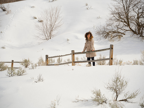 A young woman enjoying a winter hike after a fresh snowfall in Utah USA.