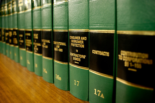 Close up of several volumes of law books of codes and statutes on consumer protection