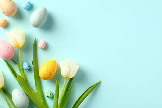 istock Happy Easter card template. Pastel blue background with colorful eggs and white tulips.easter, holiday, card, background, design, spring, poster, banner, template, celebration, decoration, minimal, april, beautiful, blossom, color, colorful, composition, 1470824157