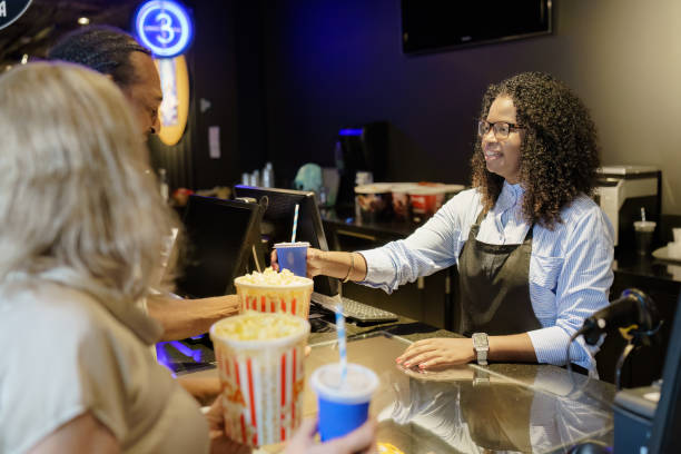 istock Cinema attendant delivering popcorn and soda refills 1470824354
