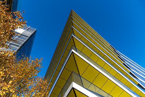 A modern apartment building with large, spacious balconies seen from below.