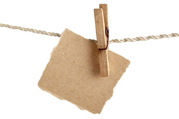 istock Craft note paper fastened with a vintage clothespin on a rope on a white background 1470826540