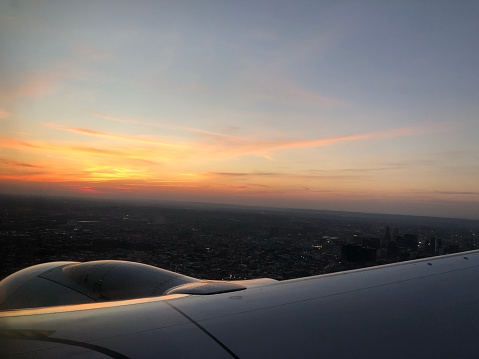 Flight taking off from Newark, New Jersey - sunset on plane
