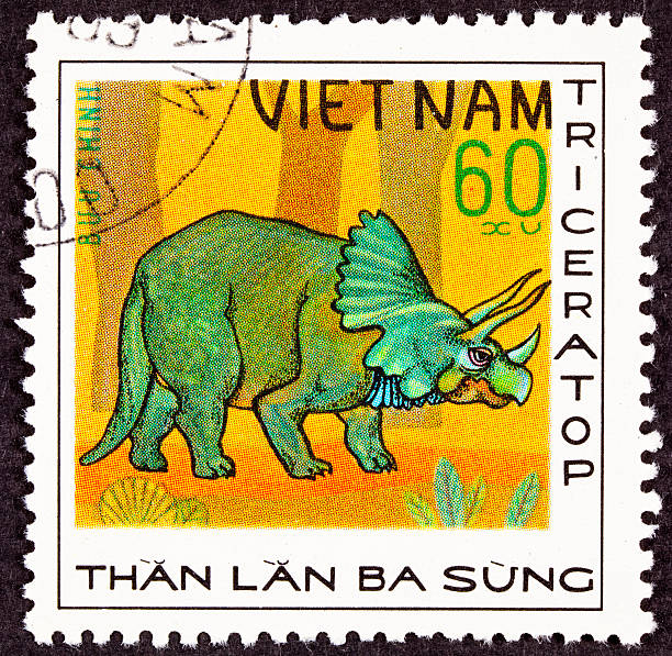 istock Canceled Vietnamese Postage Stamp Green Triceratops Dinosaur in Profile Forrest 147082699