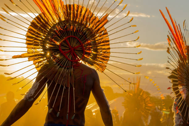 Indigenous in the evening light at the XII Indigenous Peoples Games Cuiabá, MT, Brazil - November, 13, 2013 - Indigenous in the evening light at the XII Indigenous Peoples Games blue yellow lights stock pictures, royalty-free photos & images