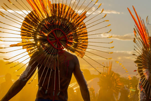 Indigenous in the evening light at the XII Indigenous Peoples Games Cuiabá, MT, Brazil - November, 13, 2013 - Indigenous in the evening light at the XII Indigenous Peoples Games indigenous culture stock pictures, royalty-free photos & images