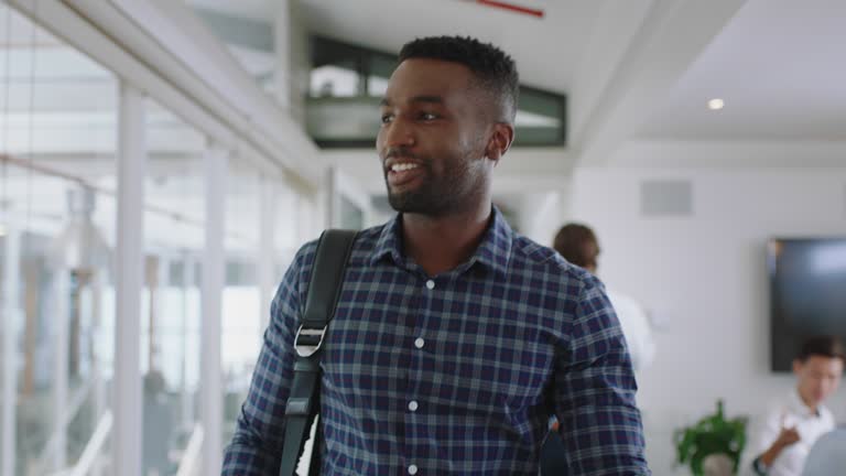 happy african american businessman  walking through office arriving at work smiling confident enjoying first day at new job 4k