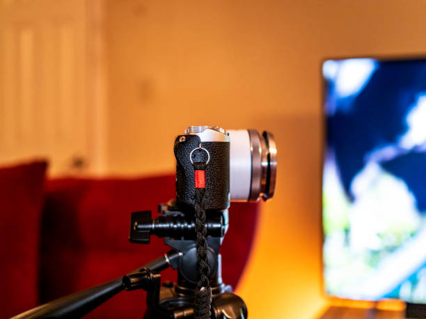 istock Camera on tripod in a living room area 1470830559