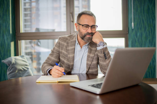 istock Mid adult man working from home 1470831506