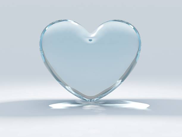 Glass heart set on a blue and white background stock photo