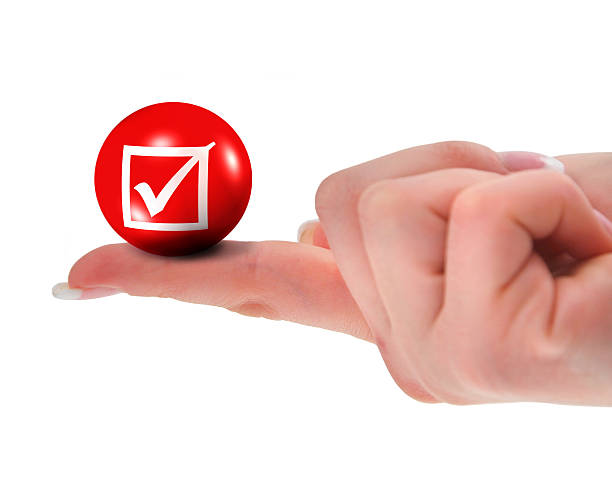 istock tick sign on finger shallow DOF 147084506