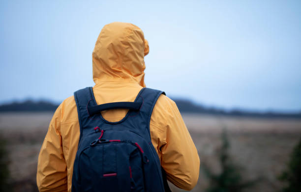 istock Young traveler with jacket, hood and backpack 1470845909