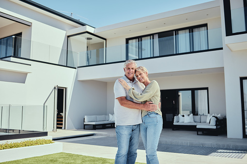 Mortgage, real estate and senior couple with house, property in Florida for retirement, love and marriage. Portrait, man and woman hug, new home and retired, relocation and moving with investment.