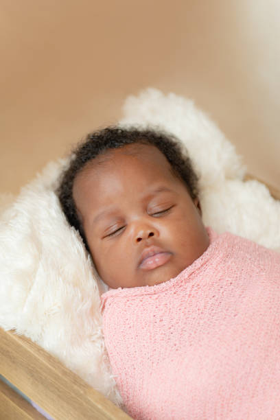 istock Black african baby girl napping wrapped up studio closeup 1470846649