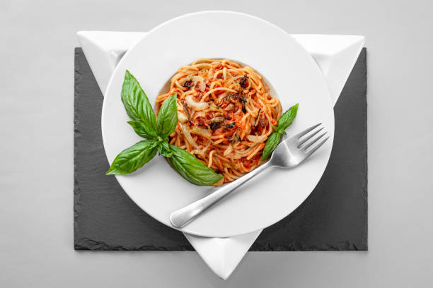Spaghetti tuna pasta basil plate triangle shape slate table pretty appetizing