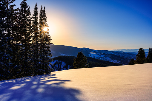 Scenic Mountains with Fresh Snow and Long Shadows - Vail, Colorado high mountain ridge view with late afternoon sunset light.