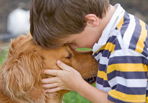 Little Boy Being Affectionate with his Dog