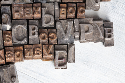 Antique vintage movable type alphabet set on wooden deck