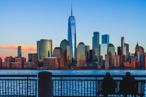 Aerial shot of the Lower Manhattan and the Freedom Tower reflecting the clouds. Shot in USA.